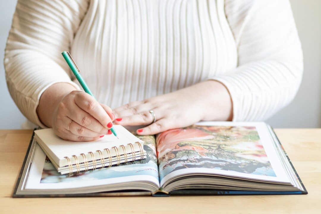 Editor reviewing printed pages with a red pen