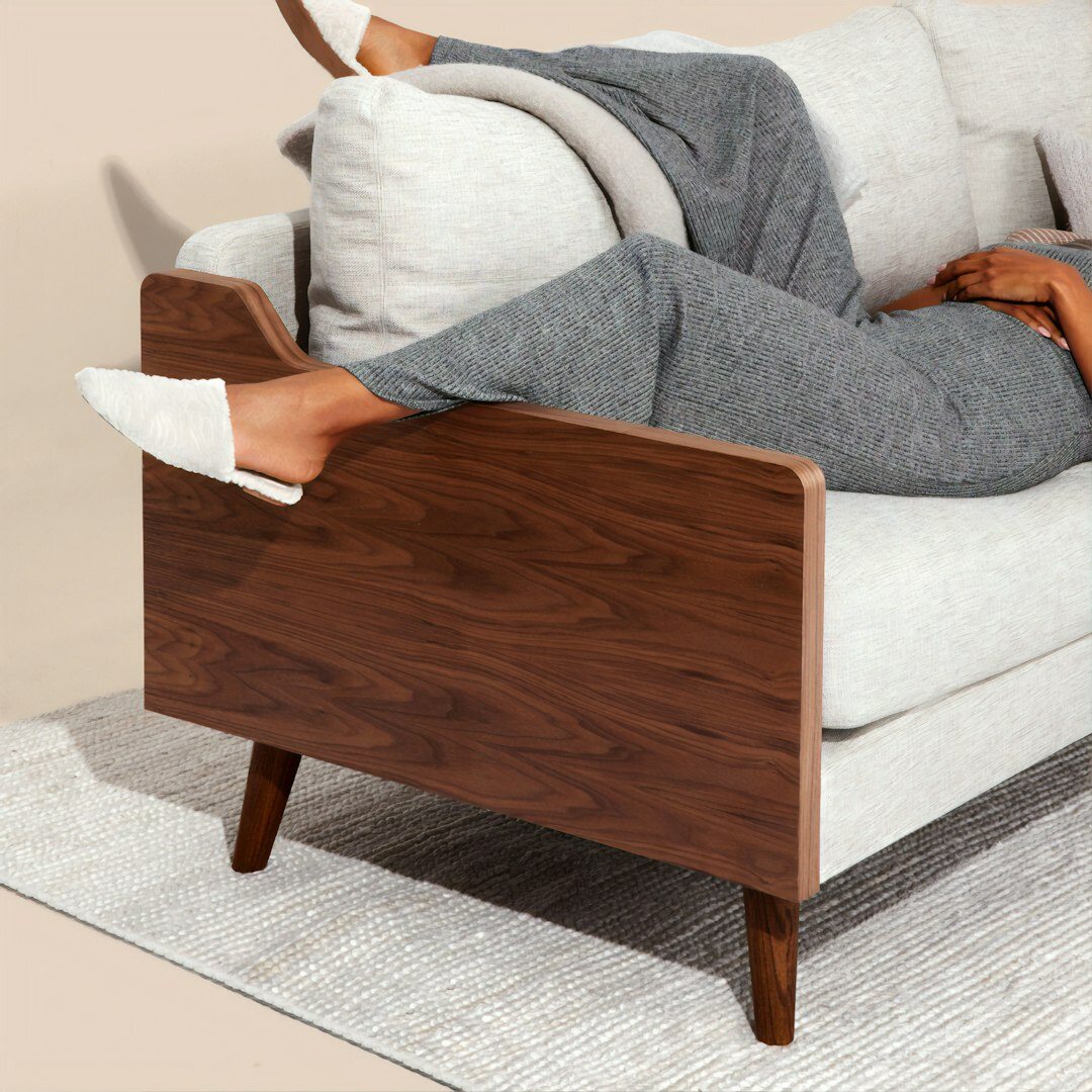 Person reading a magazine while relaxing on a sofa
